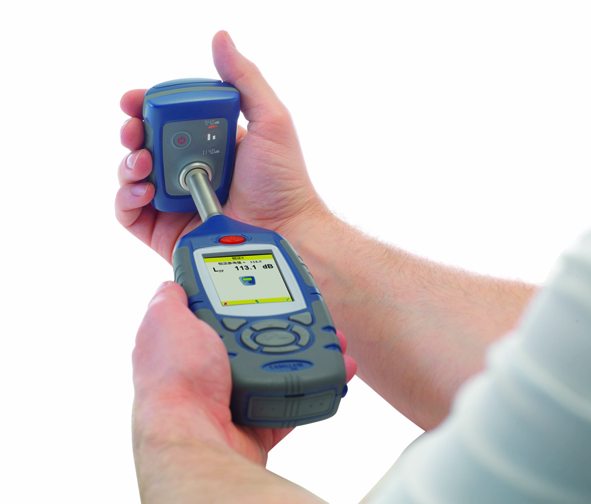 Acoustic calibrator being used to calibrate a sound level meter for occupational noise measurement